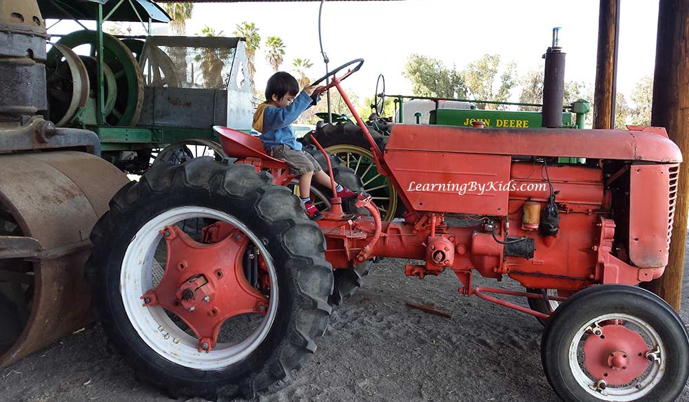 Boy and Tractor at The Antique Gas and Steam Engine Museum | LearningByKids.com